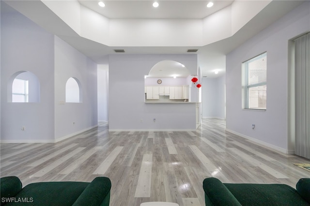 1083 Pollywog Dr, Labelle, FL 33935 - living room with light wood finished floors, baseboards, plenty of natural light, a high ceiling, and recessed lighting