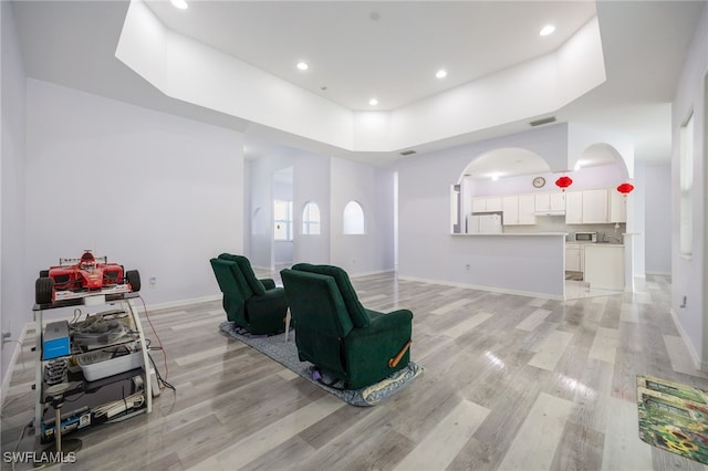 1083 Pollywog Dr, Labelle, FL 33935 - sitting room with light wood-style floors, arched walkways, baseboards, and recessed lighting