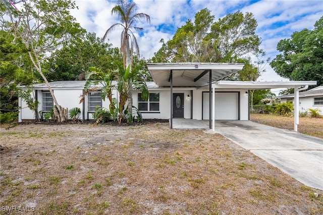 5863 Millay Ct, North Fort Myers, FL 33903 - mid-century inspired home featuring an attached garage, stucco siding, and concrete driveway