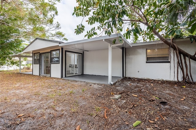 5863 Millay Ct, North Fort Myers, FL 33903 - back of house featuring stucco siding and a patio area