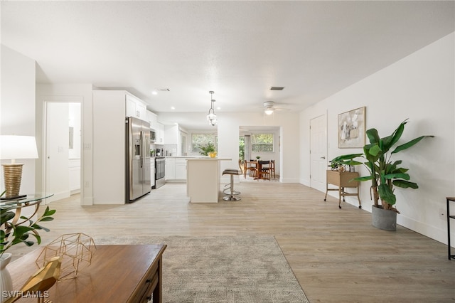 5863 Millay Ct, North Fort Myers, FL 33903 - living room featuring light wood finished floors, ceiling fan, baseboards, and recessed lighting