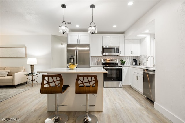 5863 Millay Ct, North Fort Myers, FL 33903 - kitchen featuring stainless steel appliances, light wood finished floors, a sink, decorative backsplash, and recessed lighting