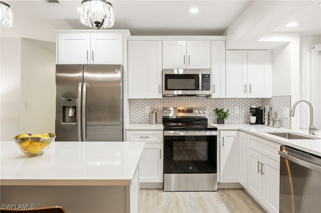 5863 Millay Ct, North Fort Myers, FL 33903 - kitchen with stainless steel appliances, a sink, light countertops, and recessed lighting