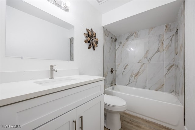 5863 Millay Ct, North Fort Myers, FL 33903 - bathroom with vanity, tub / shower combination, wood finished floors, and toilet