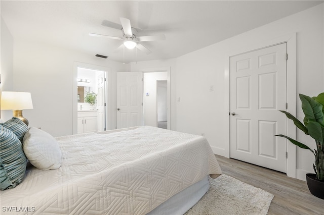 5863 Millay Ct, North Fort Myers, FL 33903 - bedroom featuring light wood-style flooring, ceiling fan, ensuite bath, and baseboards