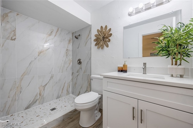 5863 Millay Ct, North Fort Myers, FL 33903 - full bath with tiled shower, toilet, vanity, and wood finished floors