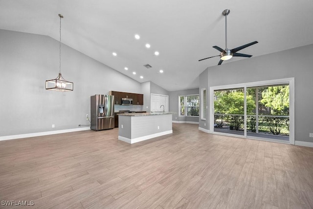 1429 Monarch Cir, Naples, FL 34116 - unfurnished living room with baseboards, light wood-style flooring, recessed lighting, a ceiling fan, and a sink