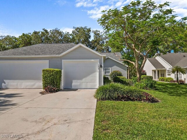 1429 Monarch Cir, Naples, FL 34116 - view of front of property with concrete driveway, a front lawn, a garage, and roof with shingles