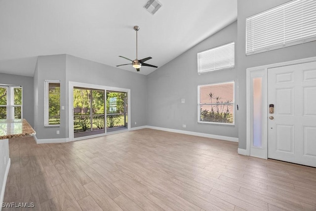 1429 Monarch Cir, Naples, FL 34116 - unfurnished living room featuring a ceiling fan, high vaulted ceiling, baseboards, and light wood-style flooring