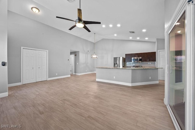 1429 Monarch Cir, Naples, FL 34116 - unfurnished living room with ceiling fan, high vaulted ceiling, light wood-style flooring, baseboards, and recessed lighting
