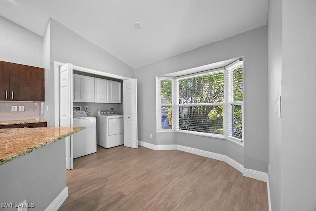 1429 Monarch Cir, Naples, FL 34116 - laundry area with cabinet space, separate washer and dryer, light wood-type flooring, and baseboards