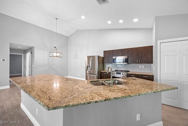 1429 Monarch Cir, Naples, FL 34116 - kitchen with appliances with stainless steel finishes, a sink, dark brown cabinets, light wood-type flooring, and recessed lighting