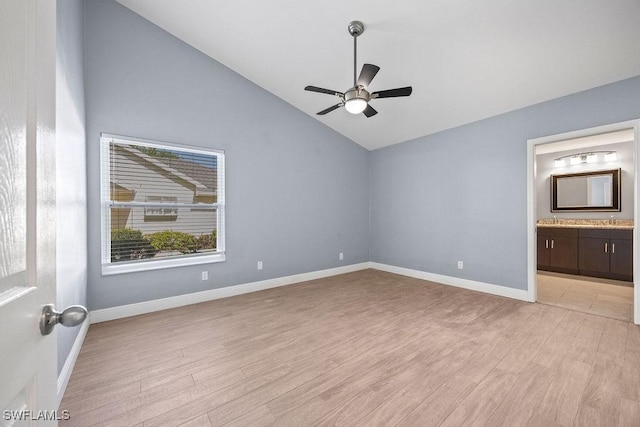 1429 Monarch Cir, Naples, FL 34116 - unfurnished bedroom with vaulted ceiling, light wood finished floors, baseboards, connected bathroom, and ceiling fan