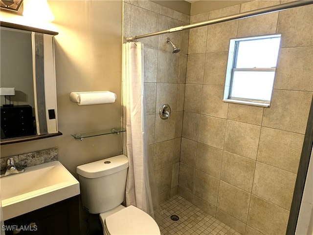 bathroom with a stall shower, toilet, and vanity
