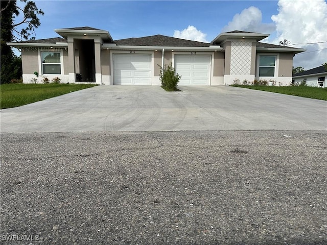 5115 30th St SW, Lehigh Acres, FL 33973 - prairie-style house with an attached garage, stucco siding, and driveway