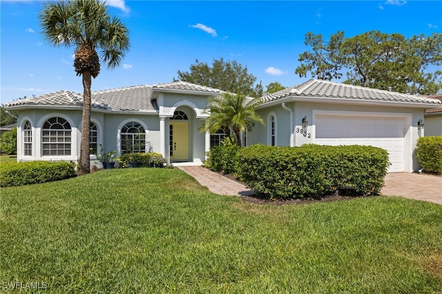 3932 Ruxton Rd, Naples, FL 34116 - mediterranean / spanish home featuring a garage, stucco siding, a front yard, and a tile roof