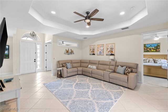 3932 Ruxton Rd, Naples, FL 34116 - living room featuring ceiling fan, a tray ceiling, light tile patterned floors, recessed lighting, and baseboards