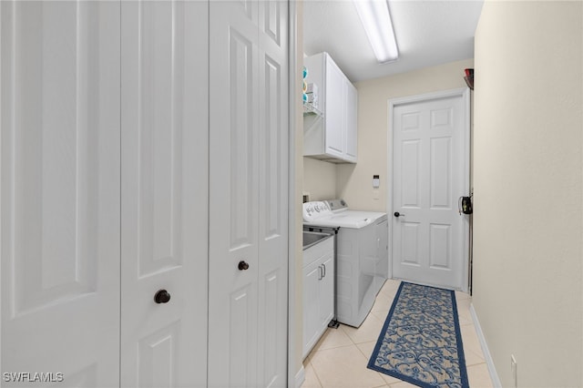 3932 Ruxton Rd, Naples, FL 34116 - laundry room with cabinet space, separate washer and dryer, light tile patterned floors, and baseboards