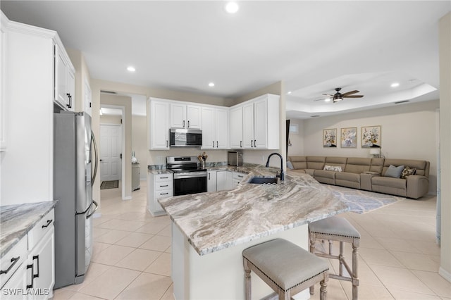 3932 Ruxton Rd, Naples, FL 34116 - kitchen featuring stainless steel appliances, a sink, a peninsula, recessed lighting, and light tile patterned flooring