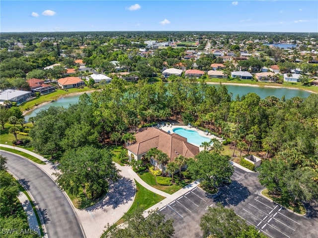 3932 Ruxton Rd, Naples, FL 34116 - bird's eye view of a pool, a nearby body of water, and a tree filled landscape