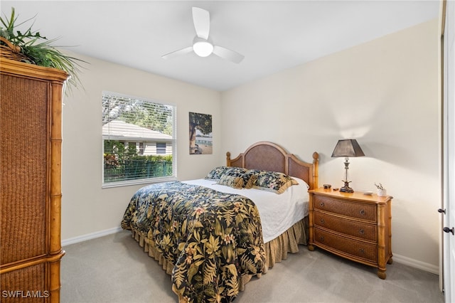 3932 Ruxton Rd, Naples, FL 34116 - bedroom with light carpet, baseboards, and ceiling fan
