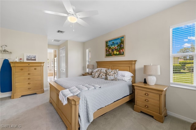 3932 Ruxton Rd, Naples, FL 34116 - bedroom with light carpet, baseboards, ensuite bathroom, and ceiling fan