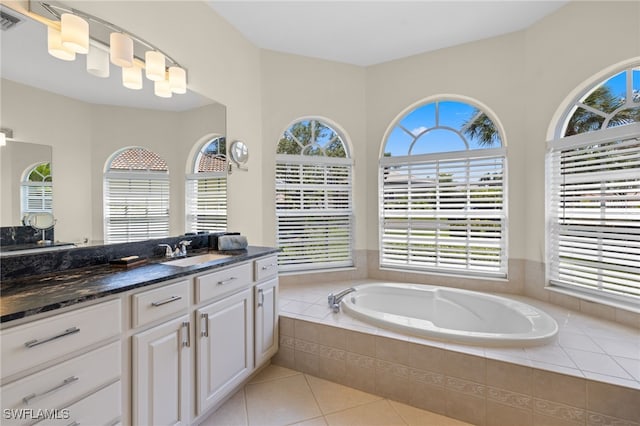 3932 Ruxton Rd, Naples, FL 34116 - bathroom featuring vanity, a garden tub, plenty of natural light, and tile patterned flooring