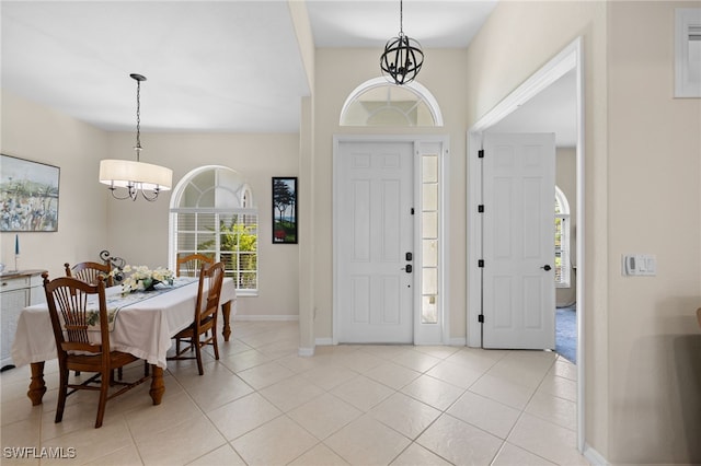 3932 Ruxton Rd, Naples, FL 34116 - entryway with a chandelier, baseboards, and light tile patterned floors