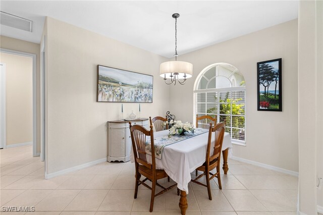3932 Ruxton Rd, Naples, FL 34116 - dining area featuring baseboards, light tile patterned floors, and a chandelier