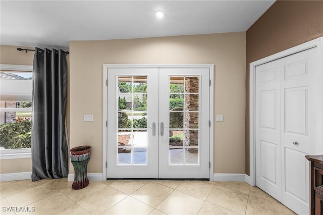 813 Saint Andrews Blvd, Naples, FL 34113 - entryway with french doors, baseboards, healthy amount of natural light, and light tile patterned floors