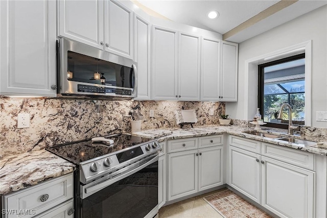 813 Saint Andrews Blvd, Naples, FL 34113 - kitchen featuring appliances with stainless steel finishes, a sink, white cabinets, tasteful backsplash, and light stone countertops