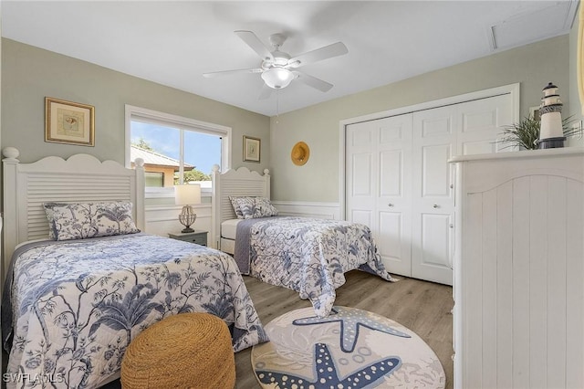 813 Saint Andrews Blvd, Naples, FL 34113 - bedroom with a closet, wood finished floors, a wainscoted wall, and ceiling fan