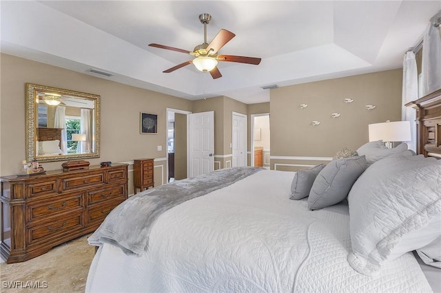 813 Saint Andrews Blvd, Naples, FL 34113 - bedroom with a raised ceiling, ensuite bathroom, and ceiling fan