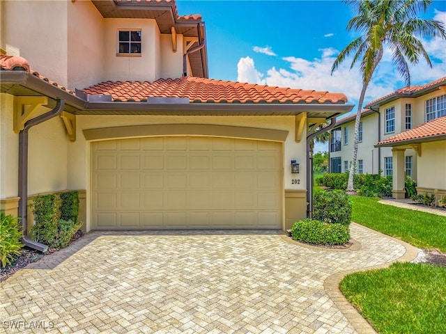 11256 Bienvenida Way Unit 6D, Fort Myers, FL 33908 - view of front facade featuring a tiled roof, stucco siding, and decorative driveway
