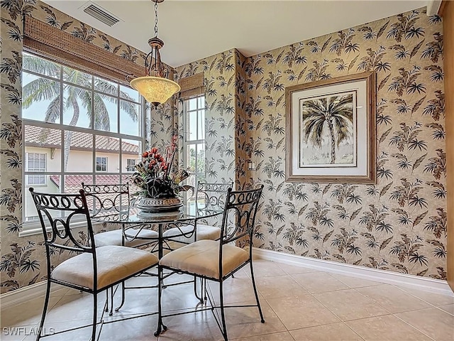 11256 Bienvenida Way Unit 6D, Fort Myers, FL 33908 - dining space with wallpapered walls, baseboards, healthy amount of natural light, and light tile patterned flooring