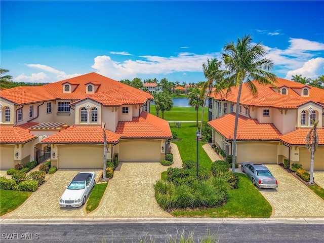 11256 Bienvenida Way Unit 6D, Fort Myers, FL 33908 - mediterranean / spanish house with a tile roof, stucco siding, decorative driveway, and a residential view