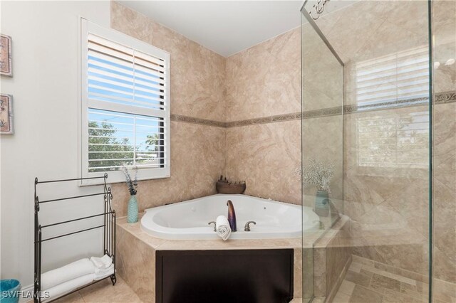 5105 Rutland Ct, Cape Coral, FL 33904 - bathroom featuring a tub with jets, tiled shower, and tile patterned flooring