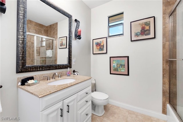 5105 Rutland Ct, Cape Coral, FL 33904 - bathroom featuring tiled shower, toilet, vanity, tile patterned floors, and baseboards
