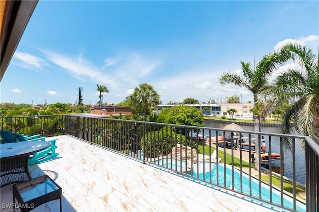 5105 Rutland Ct, Cape Coral, FL 33904 - view of patio / terrace featuring a water view, a pool with connected hot tub, and a balcony