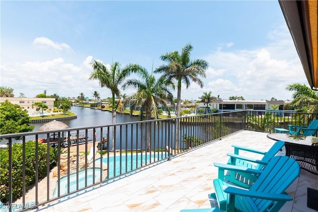 5105 Rutland Ct, Cape Coral, FL 33904 - view of patio with a water view, a pool with connected hot tub, and fence