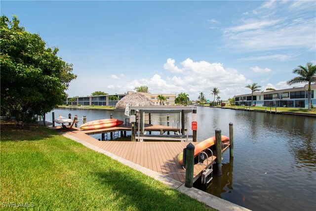 5105 Rutland Ct, Cape Coral, FL 33904 - dock area featuring a water view, boat lift, a lawn, and a residential view