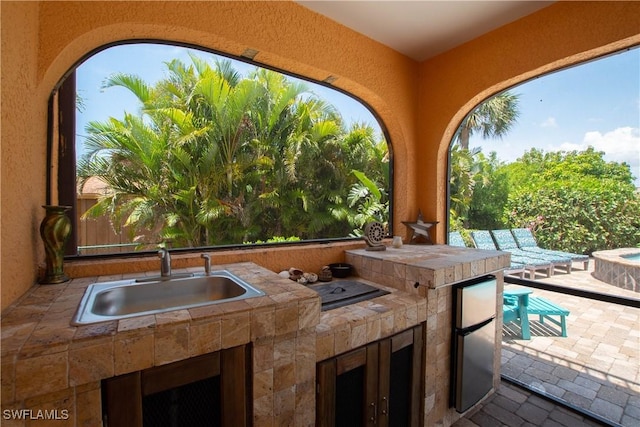 5105 Rutland Ct, Cape Coral, FL 33904 - view of patio featuring a sink, an outdoor kitchen, and an outdoor fire pit