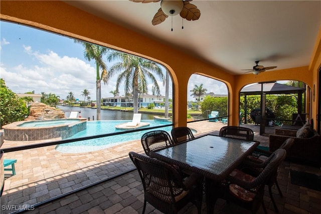 5105 Rutland Ct, Cape Coral, FL 33904 - view of patio featuring ceiling fan, a water view, a pool with connected hot tub, and an outdoor hangout area