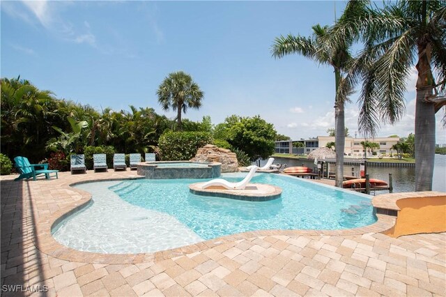5105 Rutland Ct, Cape Coral, FL 33904 - view of swimming pool featuring a pool with connected hot tub and a patio area