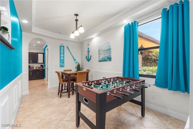 5105 Rutland Ct, Cape Coral, FL 33904 - game room featuring arched walkways, a tray ceiling, crown molding, recessed lighting, and light tile patterned floors