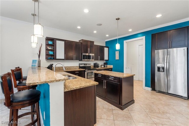 5105 Rutland Ct, Cape Coral, FL 33904 - kitchen featuring appliances with stainless steel finishes, a sink, crown molding, a peninsula, and dark brown cabinetry