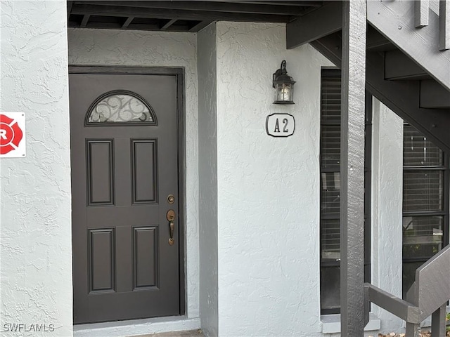 doorway to property with stucco siding