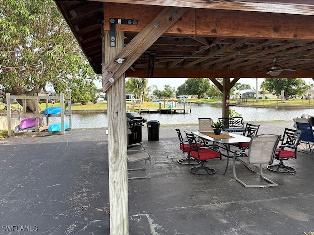 view of patio featuring a water view and grilling area