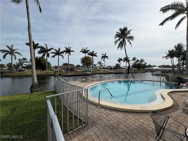 community pool featuring a water view and a patio area