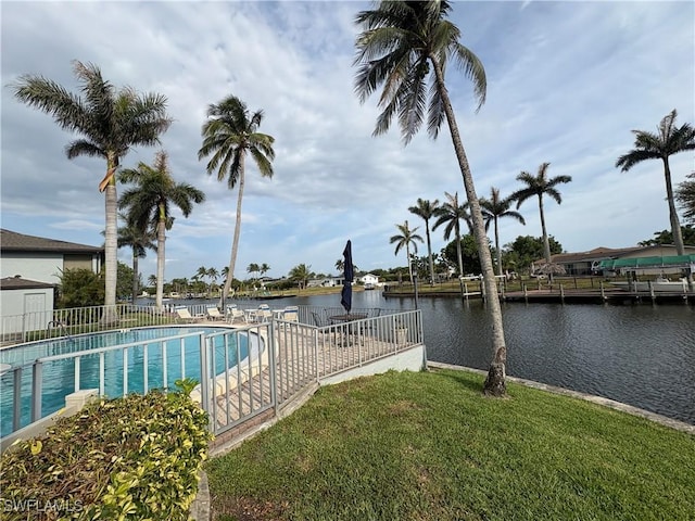 view of swimming pool featuring a water view